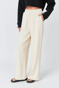 Wide knit pants from voglio.us featuring a relaxed fit with a soft, textured fabric in a neutral color.