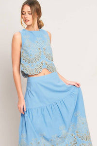 Blue eyelet midi skirt from voglio.us, showcasing lightweight fabric, eyelet detailing, and a stylish midi length.