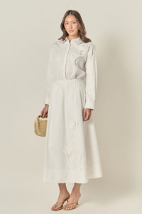 Appliqued accent midi skirt from voglio.us featuring colorful embroidery and a flowing silhouette, styled on a model.