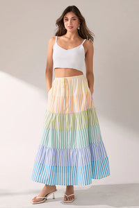 Striped color block tiered maxi skirt from voglio.us, featuring flowing fabric and bold horizontal stripes in various colors.