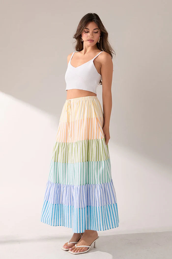 Striped color block tiered maxi skirt in vibrant hues, featuring flowing fabric and layered design from voggio.us.
