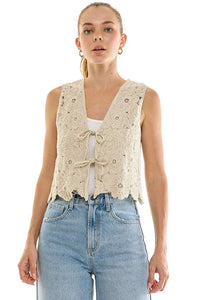 Crochet tie-front top from voglio.us featuring a stylish, lightweight design with intricate crochet detailing and a front tie closure.