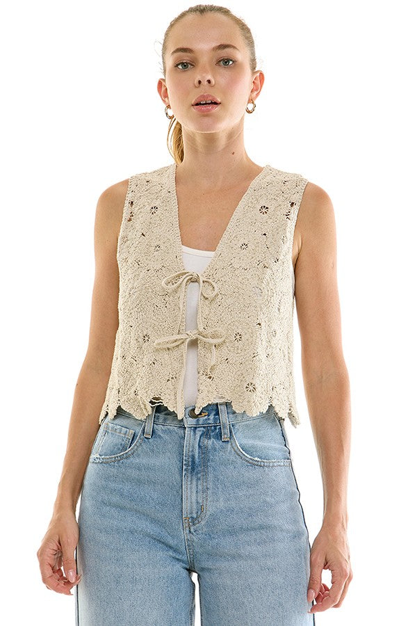 Crochet tie-front top from voglio.us featuring a stylish, lightweight design with intricate crochet detailing and a front tie closure.