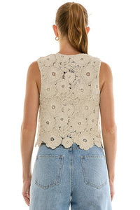 Crochet tie-front top from voglio.us featuring a textured design and short sleeves, displayed on a hanger against a plain background.