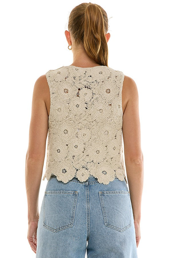 Crochet tie-front top from voglio.us featuring a textured design and short sleeves, displayed on a hanger against a plain background.