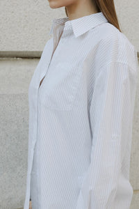 Oversized pinstripe button-down shirt from voglio.us, casual top with a relaxed fit and classic collar, shown on a hanger.