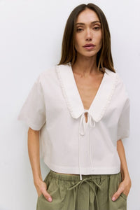 Voglio.us Roseanne V-Neck Tie Front Top, stylish women's top with v-neck and tie-front detail, shown in a flattering fit.