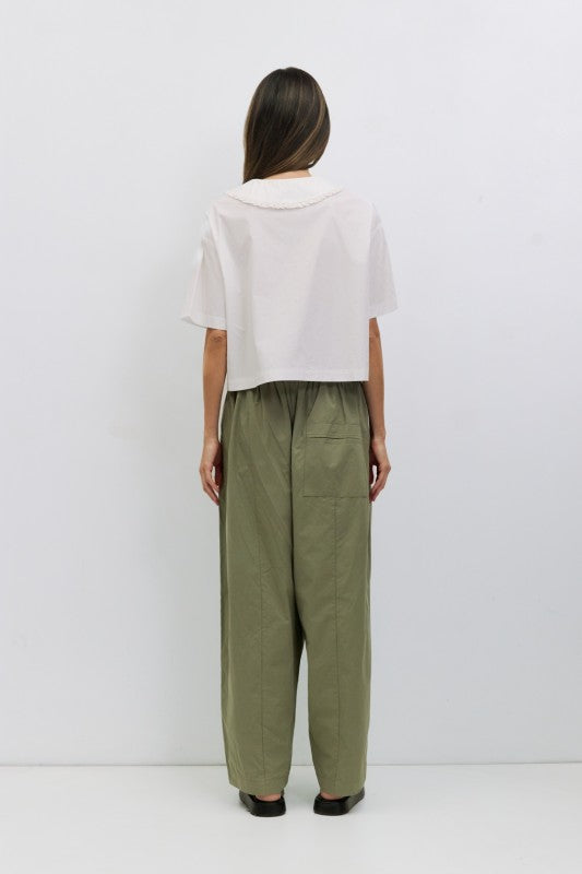 Voglio.us Roseanne V-neck tie-front top in soft fabric, featuring a stylish V-neck, long sleeves, and a front tie detail.