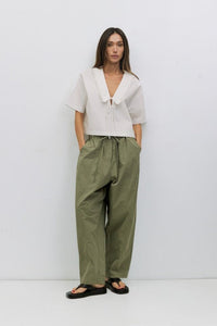 Roseanne V-neck tie-front top by voglio.us, featuring a stylish V-neckline and front knot detail, in a casual and trendy design.