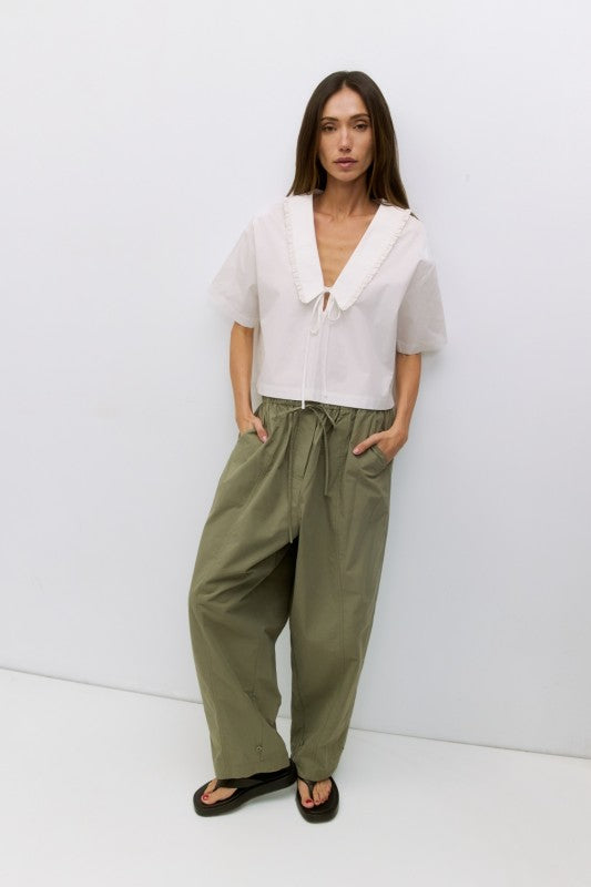Roseanne V-neck tie-front top by voglio.us, shown in pink fabric with short sleeves and a stylish V-neck design.