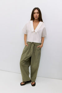 Roseanne V-neck tie-front top by voglio.us, shown in pink fabric with short sleeves and a stylish V-neck design.