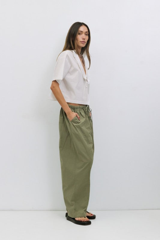 Voglio.us Roseanne V-neck tie-front top in soft fabric with long sleeves, styled on a hanger against a plain background.