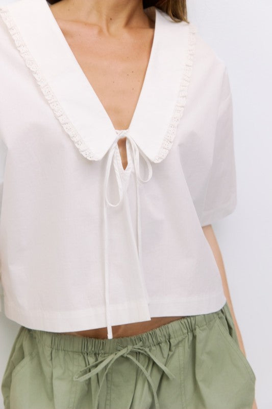 Roseanne V-neck tie front top by voglio.us, featuring lightweight fabric, long sleeves, and a stylish V-neck design.