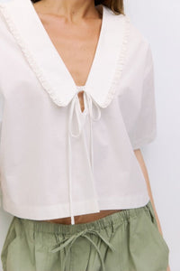 Roseanne V-neck tie front top by voglio.us, featuring lightweight fabric, long sleeves, and a stylish V-neck design.