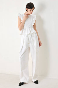 White cotton peplum top with ruffle shoulder details, stylish and feminine, by voglio.us.