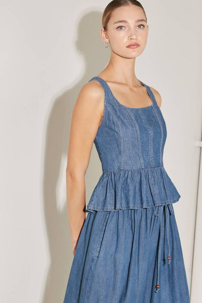 Washed denim peplum top by voglio.us, stylish sleeveless women's top with a fitted waist and trendy denim fabric.