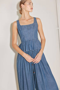 Washed denim peplum top by voglio.us, featuring a fitted waist and stylish design, shown on a model.