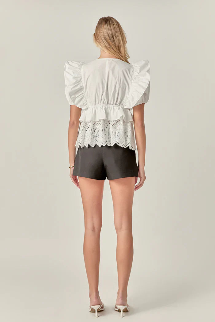 Light blue cotton eyelet blouse top with short sleeves and delicate eyelet pattern, stylish and breathable for warm weather.