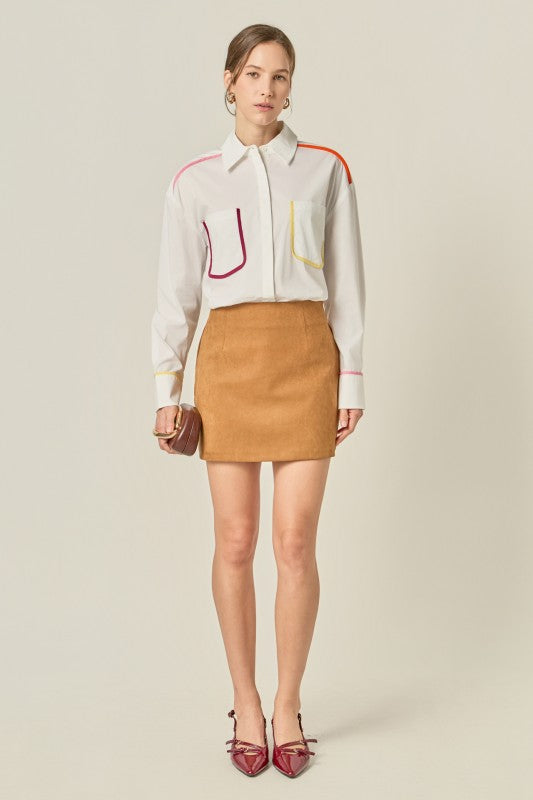 Flat binding detailed shirt top by voglio.us, featuring intricate stitching and a sleek design, shown on a model.