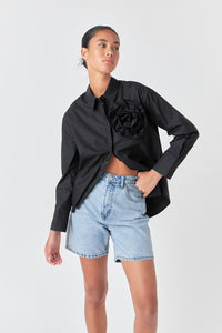 Voglio.us flower brooch shirt top featuring a decorative floral brooch pinned on a stylish shirt.