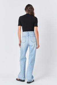 Soft black mock neck bodysuit by voglio.us, close-up of the fitted top with long sleeves and high neckline.