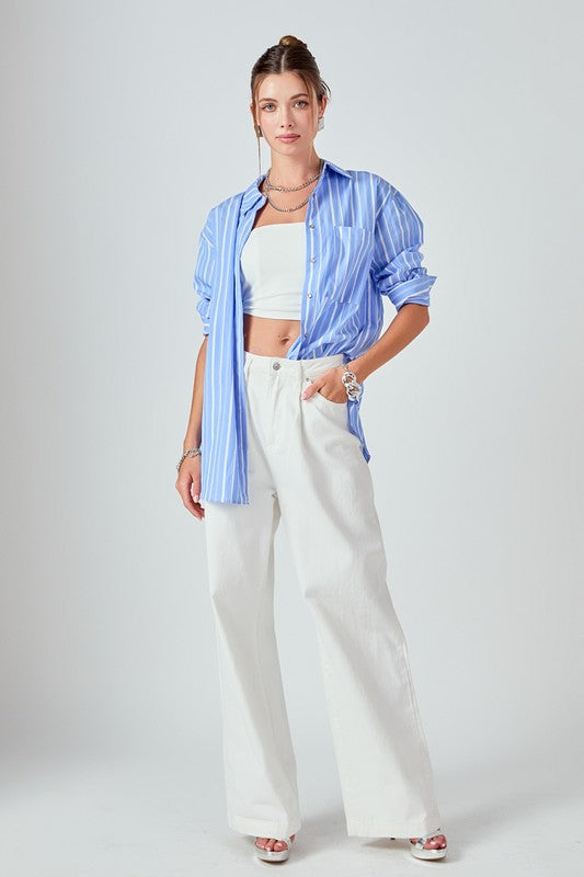 Striped oversized top by voglio.us featuring a relaxed fit and bold horizontal stripes, shown on a hanger.