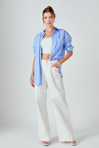 Striped oversized top by voglio.us featuring a relaxed fit and bold horizontal stripes, shown on a hanger.