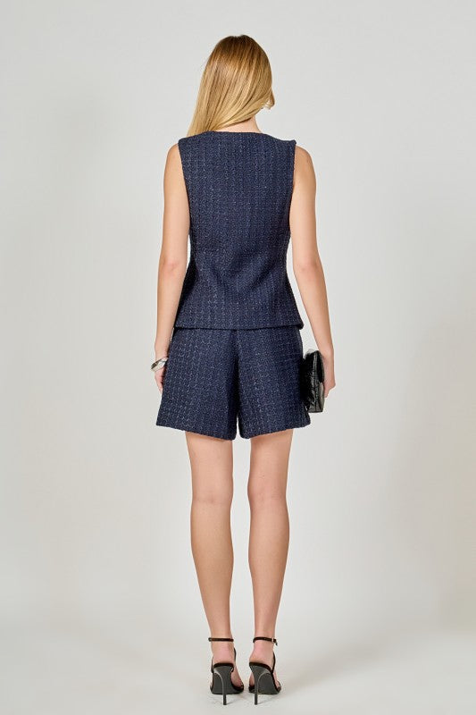 Tweed buttoned sleeveless vest top by voglio.us, featuring classic plaid pattern and tailored fit, displayed on a neutral background.