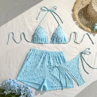 Blue three-piece bikini set for women featuring a solid color, halter top, and lace-up design, perfect for beachwear.