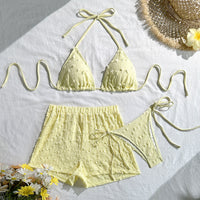 Blue three-piece bikini set for women featuring a halter neck and lace-up design, perfect for stylish swimming and beach wear.