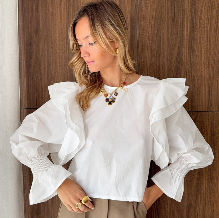 White polyester cotton long-sleeved top with flying sleeves, backless design, hollow-out cutout, ideal for women's office fashion.