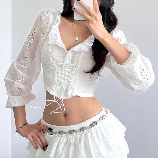 White women's crochet long sleeve crop top with lace-up design, perfect for autumn fashion and stylish casual wear.