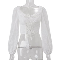 White women's long sleeve crochet crop top with lace-up detail, perfect for autumn fashion, from Wanita Store.