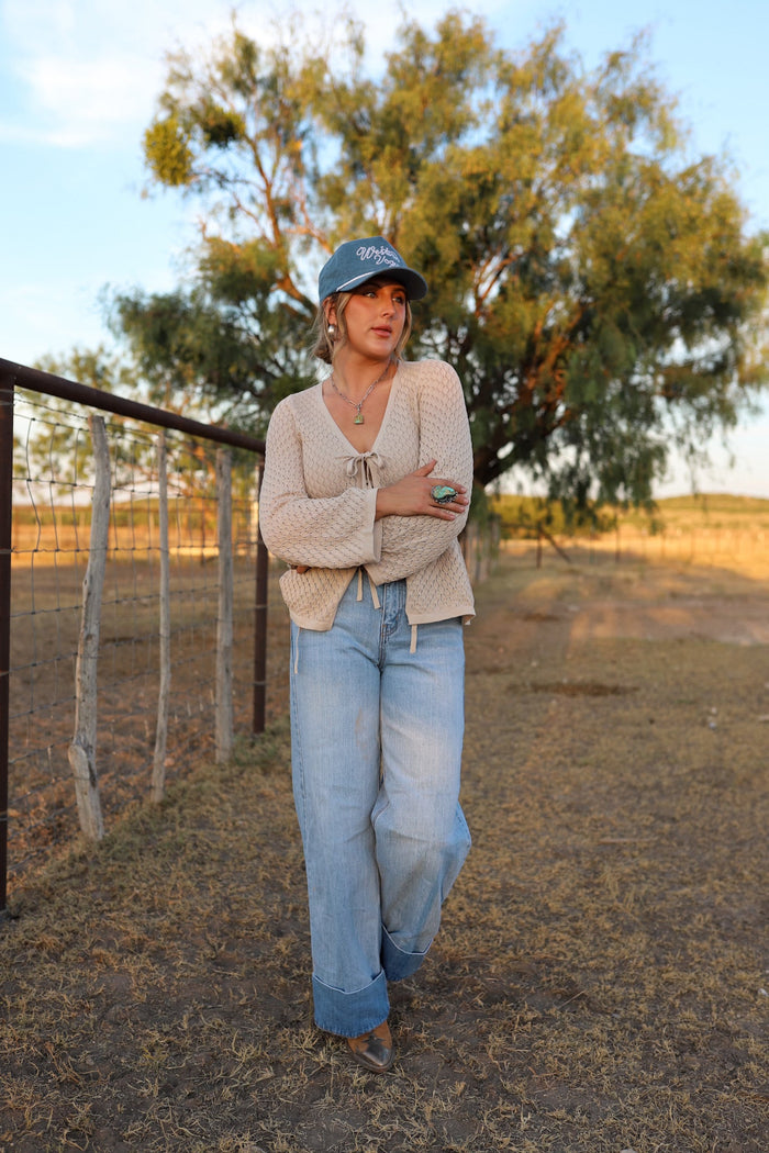Light wash Cambree jeans by Western Vogue Boutique, stylish denim bottoms with classic fit and subtle fading.