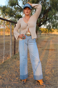 Light wash jeans from Western Vogue Boutique's Cambree collection, showcasing classic denim bottoms with a relaxed fit.