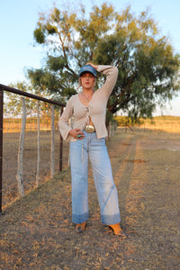 Light wash Cambree jeans by Western Vogue Boutique, stylish denim bottoms with classic five-pocket design and relaxed fit.
