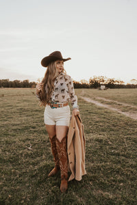 White creamy shorts by Western Vogue Boutique, casual bottom with a soft, comfortable fit and stylish design.