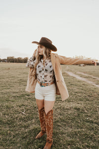 White creamy shorts from Western Vogue Boutique featuring a relaxed fit and stylish design, perfect for casual summer wear.