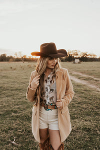 White creamy shorts from Western Vogue Boutique featuring a relaxed fit and stylish design, perfect for casual summer wear.