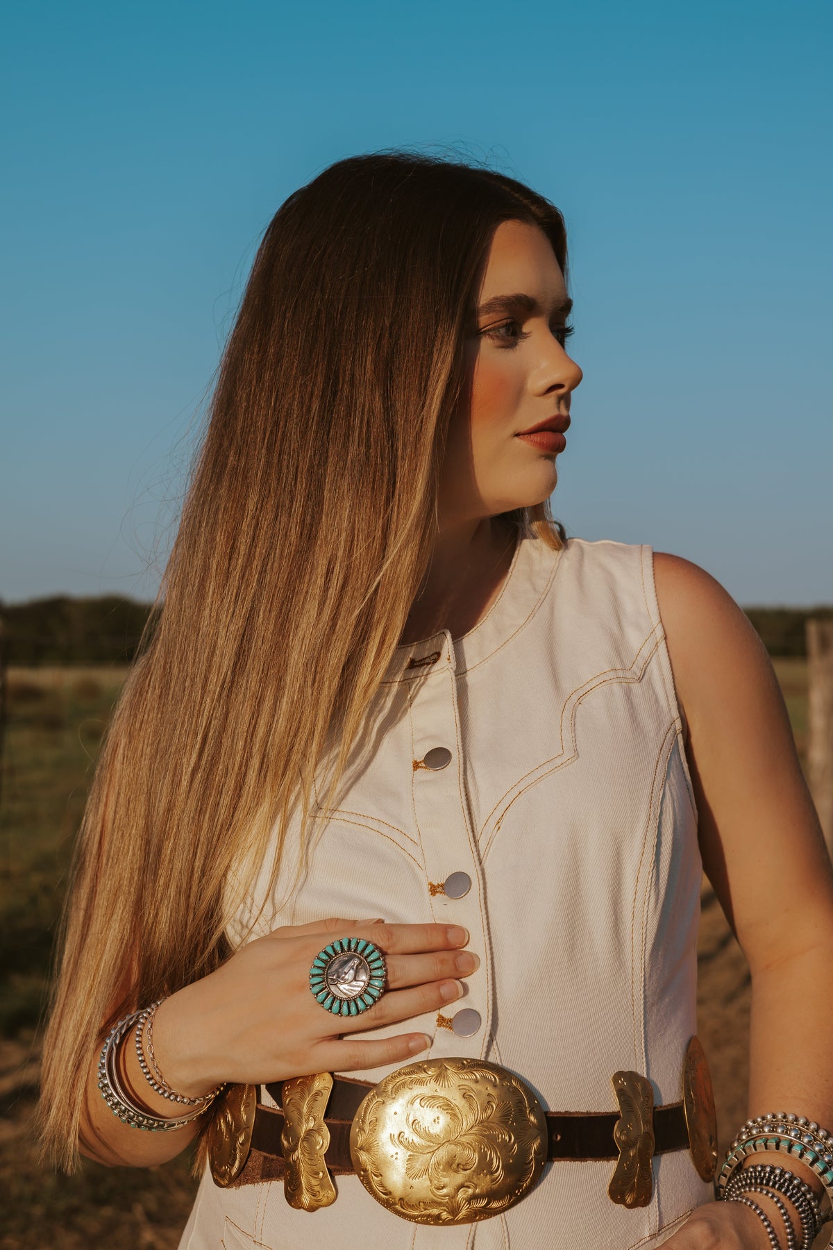 Women's denim dress by Western Vogue Boutique featuring a classic fit, front buttons, and a stylish sleeveless design.