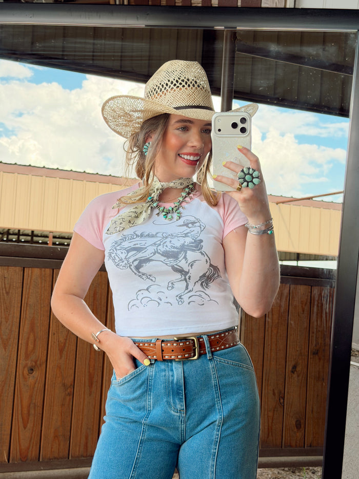 Women's The Cowboy Doodle T-Shirt by Western Vogue Boutique, featuring a western-inspired graphic on a casual top.