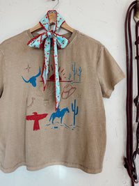 Western Vogue Boutique cowboy-themed T-shirt featuring western-style graphics and casual fit, perfect for Western-inspired fashion.