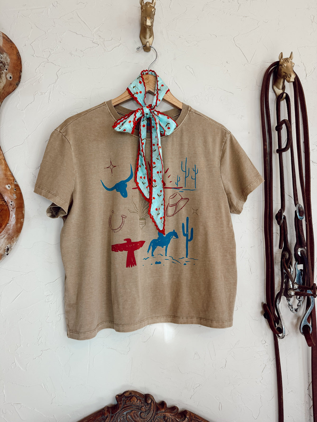 Western Vogue Boutique cowboy-themed T-shirt featuring Western graphics and casual style, perfect for Western-inspired outfits.