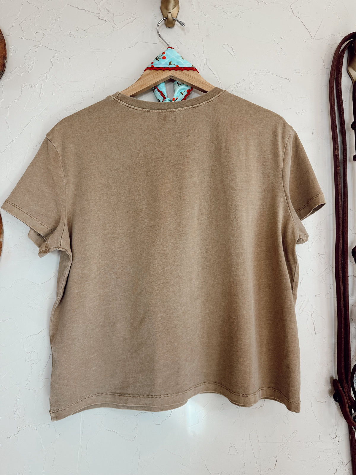 Western Vogue Boutique cowboy-themed T-shirt with graphic design, casual fit, and western-inspired artwork on lightweight cotton top.