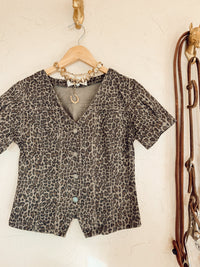 Leopard print denim top from Western Vogue Boutique featuring long sleeves and a casual fit.