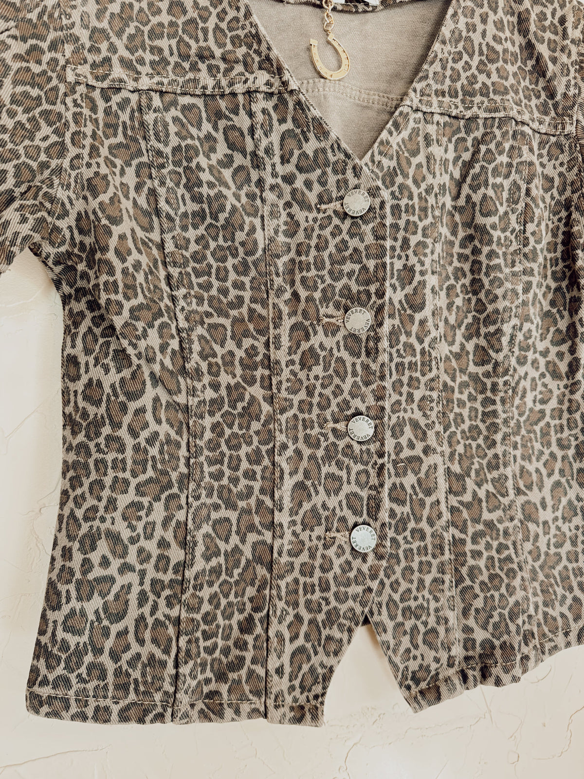 Leopard print denim top from Western Vogue Boutique featuring long sleeves and a fitted design.