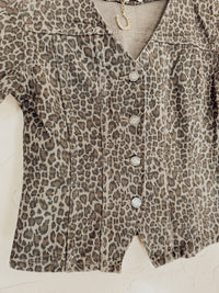 Leopard print denim top from Western Vogue Boutique featuring long sleeves and a fitted design.