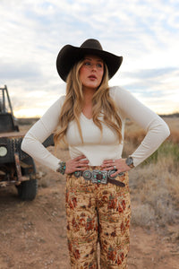 Cream Sloan top by Western Vogue Boutique featuring a stylish design, displayed on a hanger against a neutral background.
