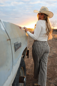 Cream Sloan Top by Western Vogue Boutique, showcasing a stylish women's sleeveless blouse with a relaxed fit.
