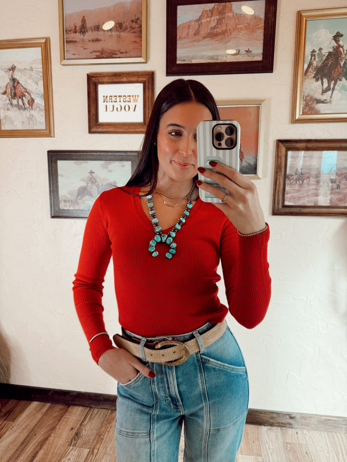 Red Sloan Top by Western Vogue Boutique, showcasing a stylish women’s blouse with a flattering fit and elegant design.